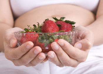 Close-up of hand holding strawberries