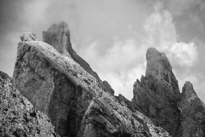 Low angle view of rock formation against sky