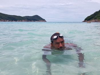 Portrait of man in sea against sky