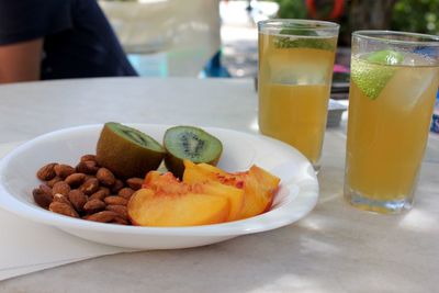 Close-up of fruits and drink on table