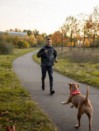 Full length of man with dog on road