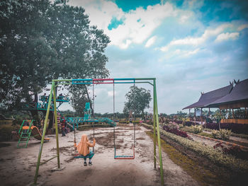 Panoramic view of playground against buildings