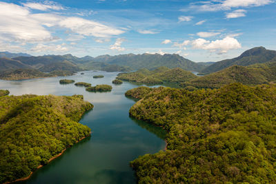 Lake and islands among mountains and hills against the blue sky and clouds. randenigala reservoir