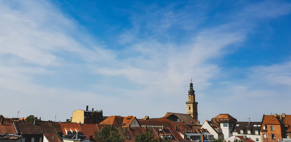 Buildings in town against sky