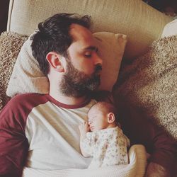 High angle view of baby sleeping on sofa at home