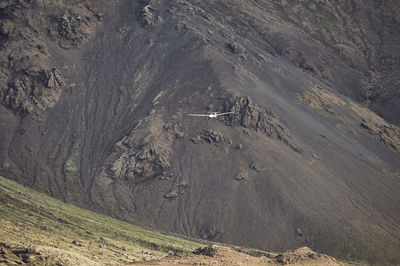 White plane amid brown hillside