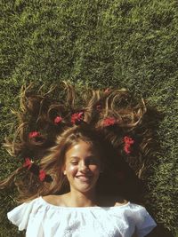 Portrait of happy woman lying on grass