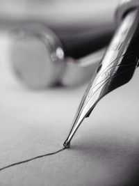 Close-up of pen on table