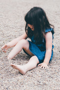 Girl sitting on sand