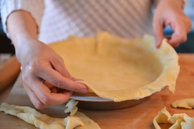 Close-up of woman preparing food on cutting board