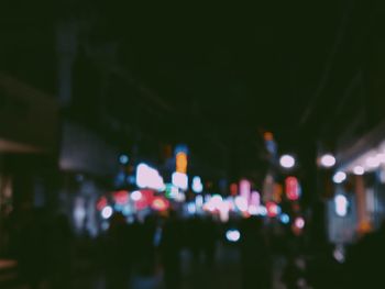 Defocused image of illuminated city street at night