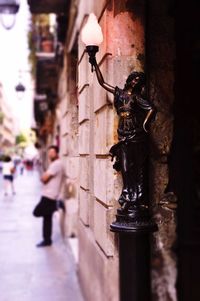 Close-up of lamp in city
