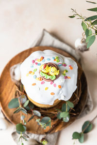 Kulich. traditional orthodox easter sweet bread decorated with meringue icing and candy shaped eggs
