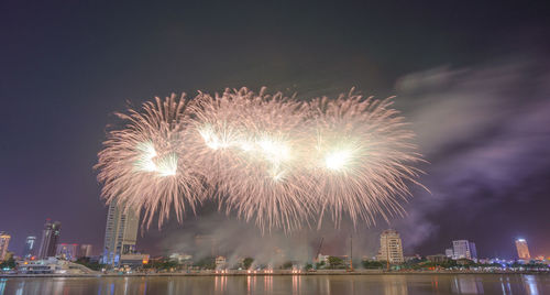 Low angle view of firework display at night