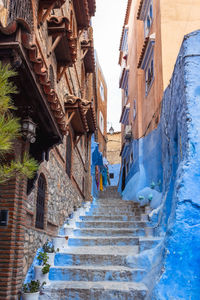 Low angle view of narrow alley amidst buildings