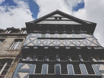 Low angle view of building against cloudy sky