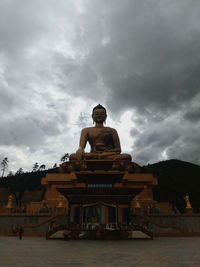 Statue of temple against cloudy sky