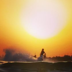 Silhouette of woman at sunset