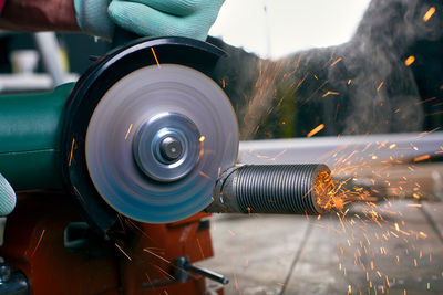 Close-up of man working on motorcycle