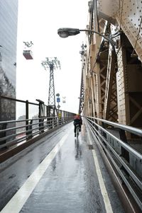 Woman walking on footbridge