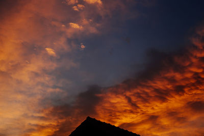 Low angle view of dramatic sky during sunset