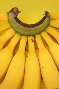 Close-up of bananas on yellow background