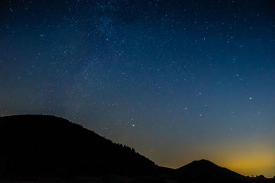 Low angle view of silhouette mountain against sky at night. via lattea -piani di montelago