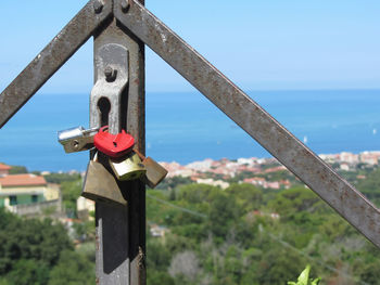 Many love padlocks, one heart shaped, closeup on a blurred background in summer