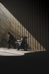 Motorbike on street against wall
