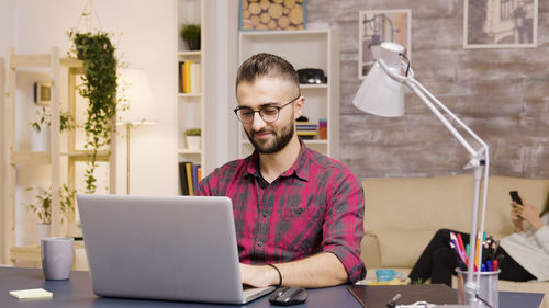 Young man using laptop at home