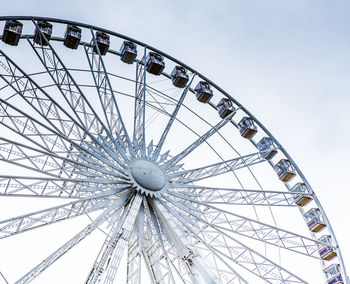 Low angle view of ferris wheel against sky