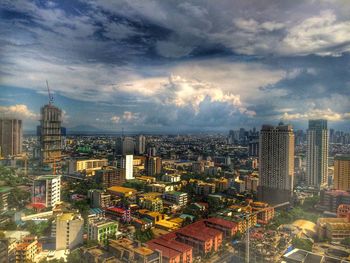 Cityscape against cloudy sky