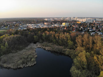 High angle view of river by buildings in city against sky