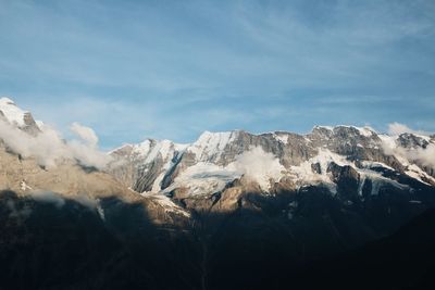 Scenic view of snow mountains against sky