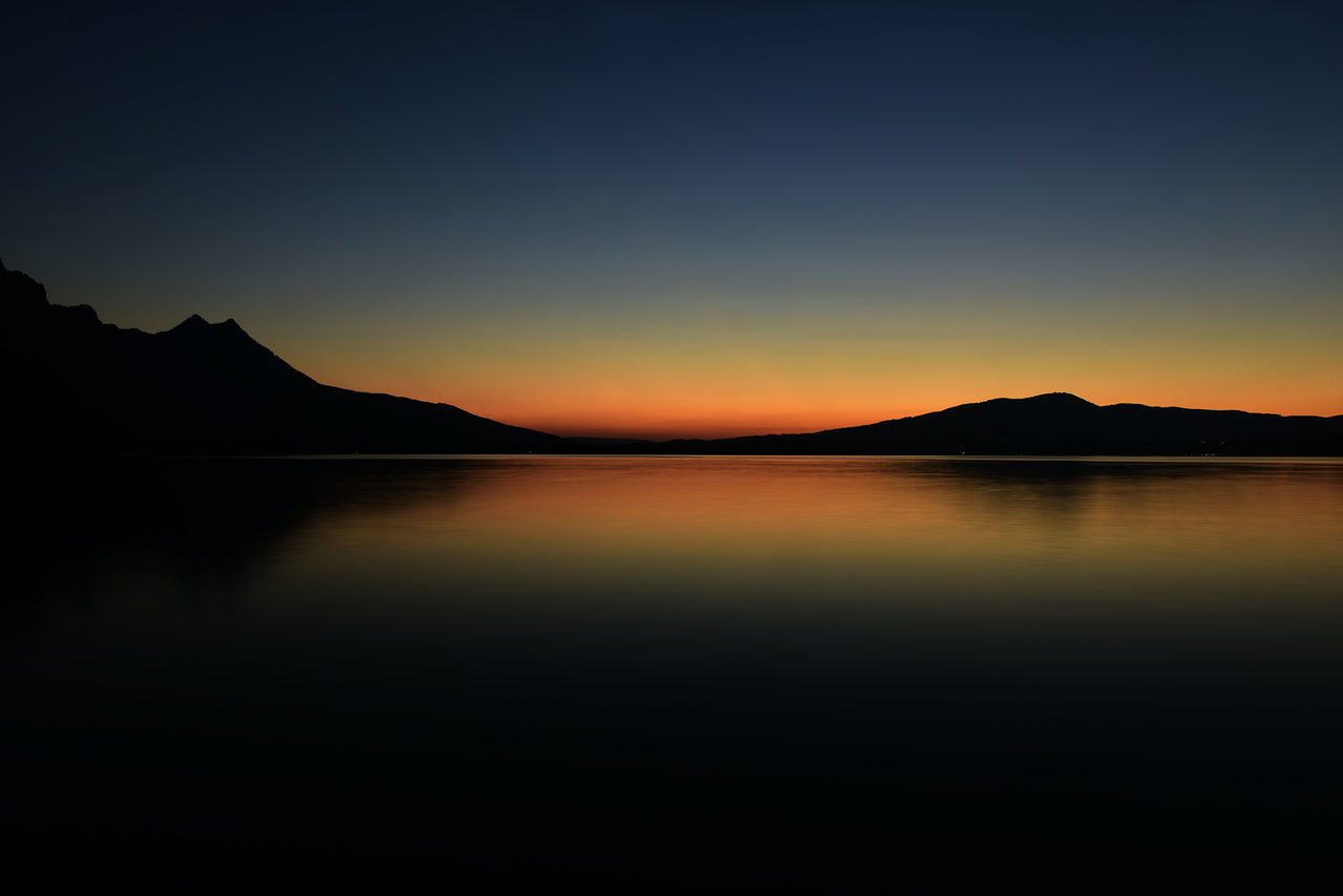 SCENIC VIEW OF LAKE AT SUNSET