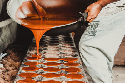 Low section of man working on table