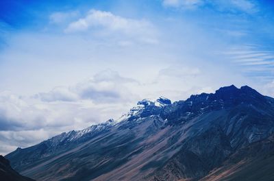 Scenic view of snowcapped mountain against cloudy sky