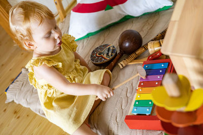 High angle view of cute girl playing with toys on table