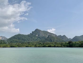 Scenic view of sea and mountains against sky