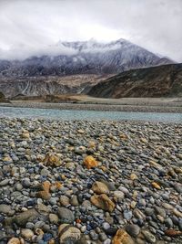 Colourful stones on the riverbed against the backdrop of the himalayas