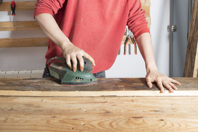 Midsection of woman working on table
