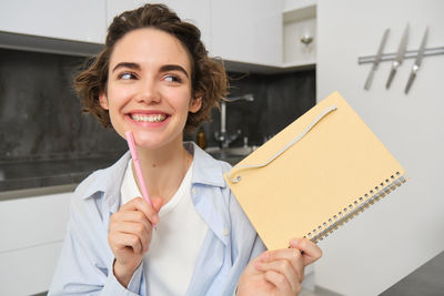 Portrait of smiling young woman using digital tablet