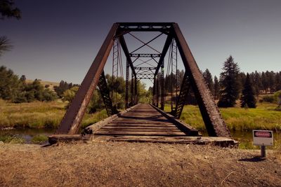 Rusty metallic bridge against clear sky