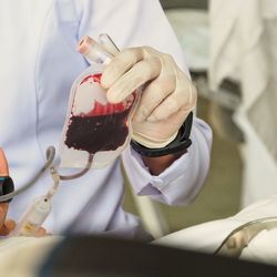 Midsection of doctor testing blood in hospital