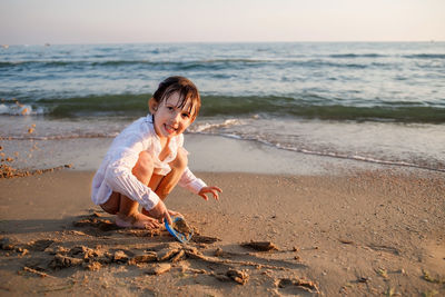 Full length of girl playing on beach