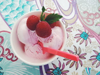 Close-up of ice cream and raspberries in bowl on table