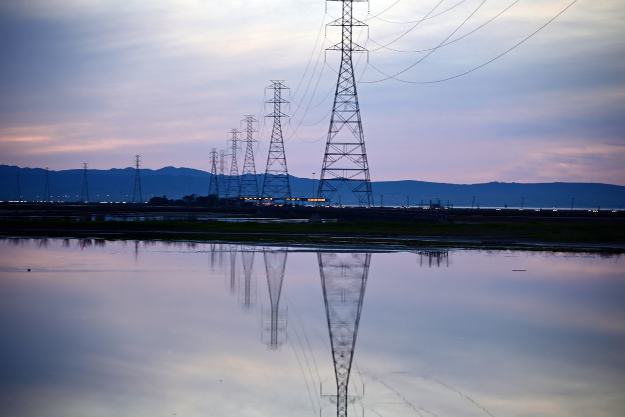 reflection, sky, electricity, technology, cable, electricity pylon, water, cloud, power supply, power generation, transmission tower, power line, nature, dusk, sunset, no people, horizon, tower, environment, scenics - nature, beauty in nature, tranquility, overhead power line, evening, architecture, outdoors, industry, silhouette, landscape, electrical supply, business finance and industry, built structure, lake, blue, sunlight, tranquil scene, twilight, power station, dramatic sky