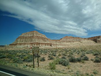 View of desert against cloudy sky