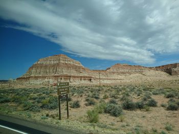 View of desert against cloudy sky