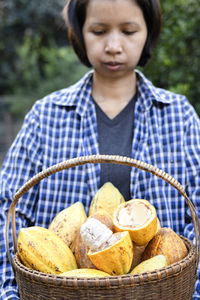 Portrait of woman holding wicker basket